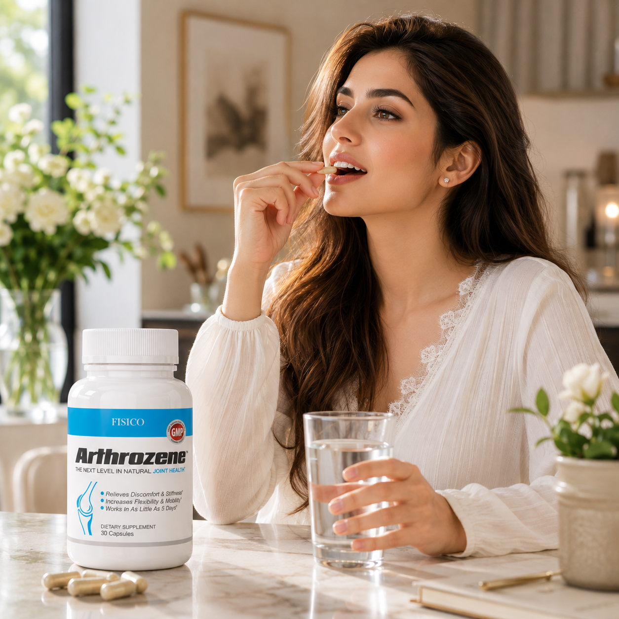 A woman in a white lace-trim blouse sits at a table taking a pill from a bottle labeled FISCO Arthrozene, with a glass of water and loose capsules nearby in a bright indoor setting.