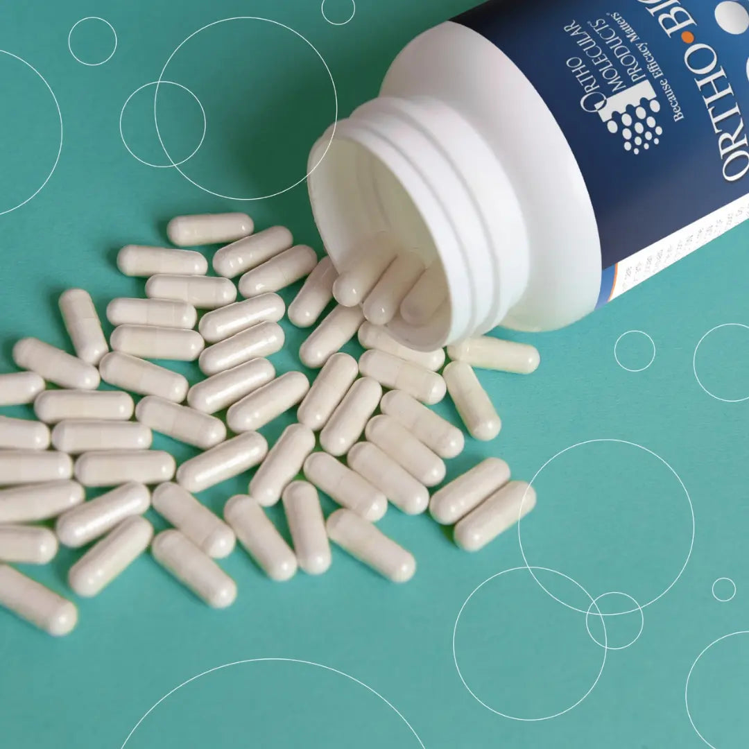 Ortho-BF supplement bottle with capsules on a teal background