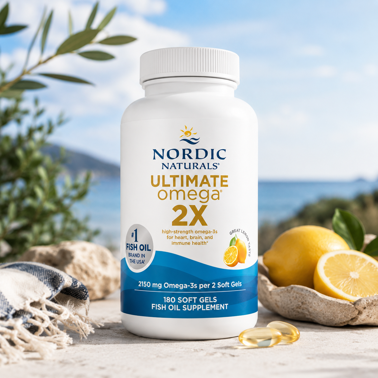  Ultimate Omega 2X fish oil supplement bottle, 180 soft gels, displayed on a rustic stone surface with lemons, a woven throw, and an outdoor ocean background.