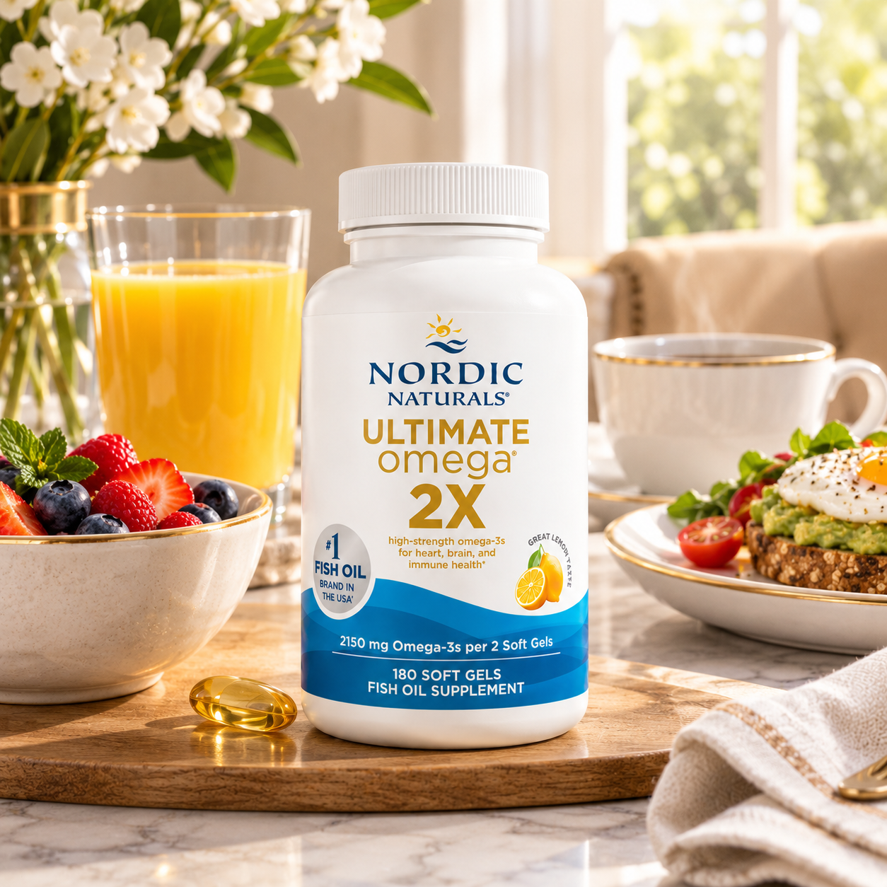  Ultimate Omega 2X fish oil supplement bottle displayed on a wooden tray in a bright kitchen setting, surrounded by a glass of orange juice, fresh berries, and an avocado toast.