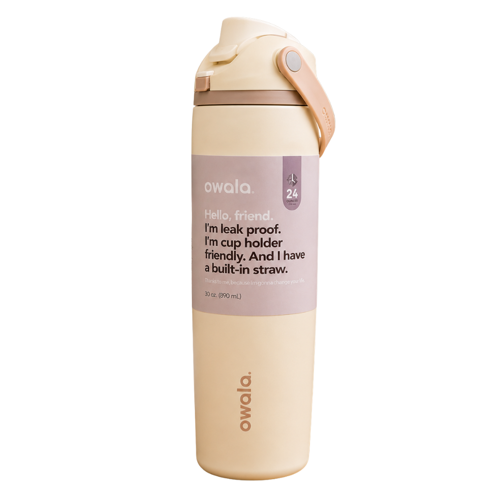An Owala 24 oz insulated water bottle with a built-in straw, featuring a warm cream body, a dusty lavender label with black text, and a matching cream lid with a tan loop handle, set against a plain white background.