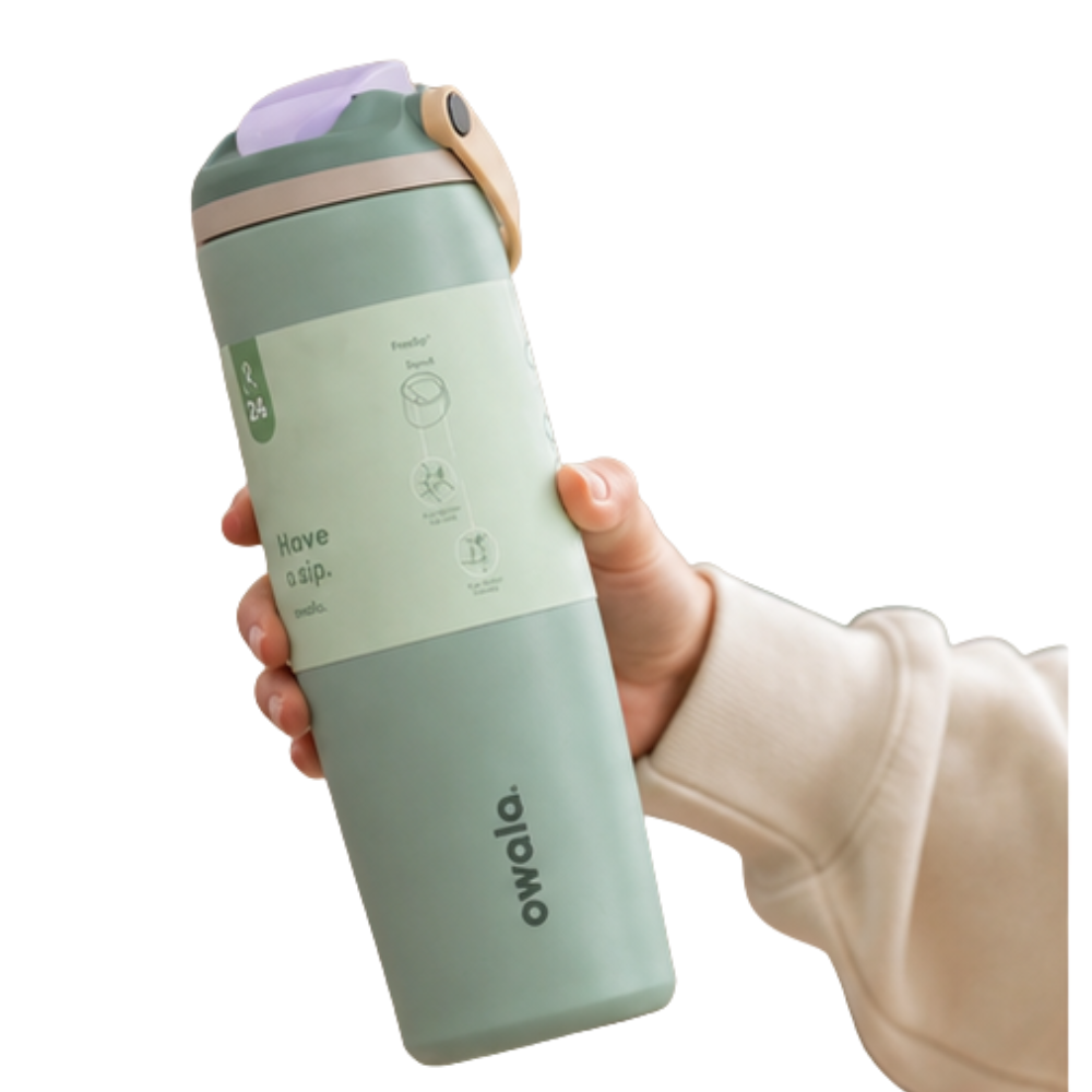 A hand holding a mint green Owala travel tumbler with a light purple lid and a beige sleeve on a white background.